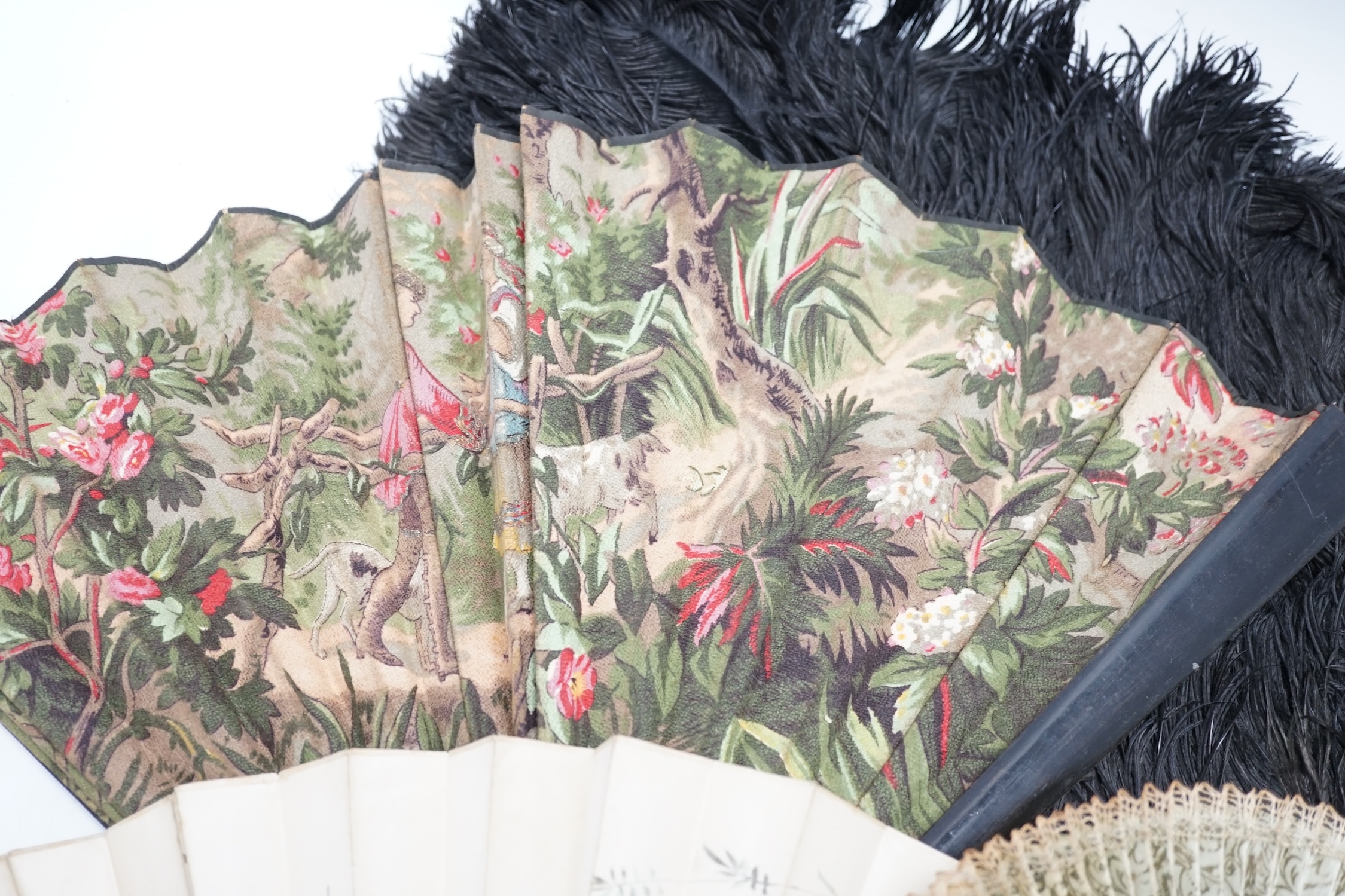 A black ostrich feather and tortoiseshell fan and four others including a carved bone and floral painted silk example. Condition - poor to fair